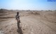 A person standing in the middle of a desert.