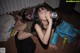 A woman laying on the floor drinking from a can.