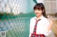 A young woman in a school uniform posing for a picture.